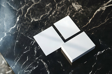 Elegant business cards atop a dark, veined marble surface, perfect for showcasing minimalistic branding and upscale corporate identity presentation