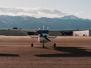 small single engine plane in front of mountain range