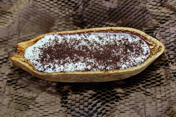 Traditional cupuaçu cream, cupuaçu mousse served in the fruit shell with grated chocolate