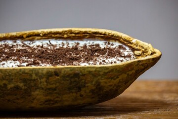 Traditional cupuaçu cream, cupuaçu mousse served in the fruit shell with grated chocolate