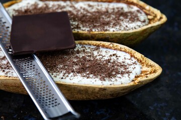 Traditional cupuaçu cream, cupuaçu mousse served in the fruit shell with grated chocolate