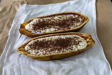 Traditional cupuaçu cream, cupuaçu mousse served in the fruit shell with grated chocolate