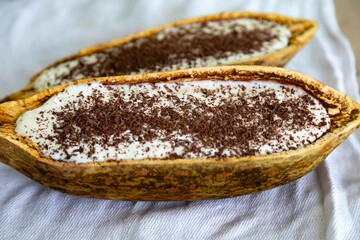 Traditional cupuaçu cream, cupuaçu mousse served in the fruit shell with grated chocolate