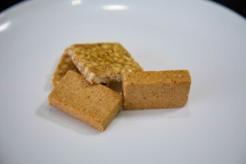 Paçoquinha is a sweet, crumbly Brazilian peanut candy made from ground peanuts and sugar, often enjoyed as a nostalgic snack