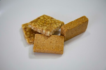 Paçoquinha is a sweet, crumbly Brazilian peanut candy made from ground peanuts and sugar, often enjoyed as a nostalgic snack