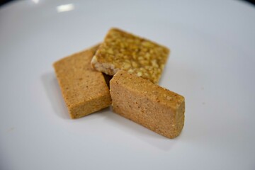 Paçoquinha is a sweet, crumbly Brazilian peanut candy made from ground peanuts and sugar, often enjoyed as a nostalgic snack