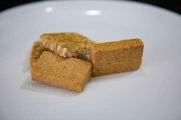 Paçoquinha is a sweet, crumbly Brazilian peanut candy made from ground peanuts and sugar, often enjoyed as a nostalgic snack