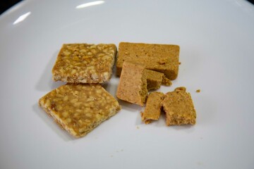 Paçoquinha is a sweet, crumbly Brazilian peanut candy made from ground peanuts and sugar, often enjoyed as a nostalgic snack
