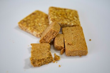 Paçoquinha is a sweet, crumbly Brazilian peanut candy made from ground peanuts and sugar, often enjoyed as a nostalgic snack