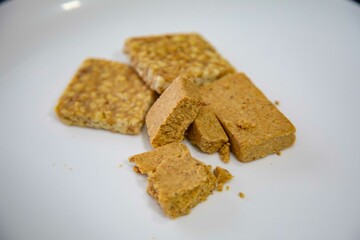 Paçoquinha is a sweet, crumbly Brazilian peanut candy made from ground peanuts and sugar, often enjoyed as a nostalgic snack