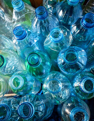 A collection of empty, transparent plastic bottles with blue caps, arranged closely together, viewed from above. Generative AI