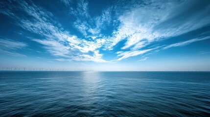 Fototapeta premium Offshore Wind Turbines Under a Blue Sky