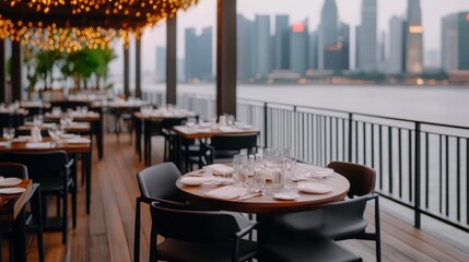 Obraz premium Waterfront Restaurant Tables with skyline view prepared for dinner service, upscale