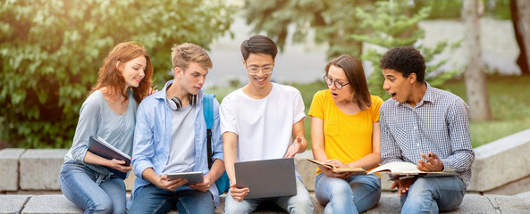 Students Lifestyle. Group Of Millennials Learning Together Working On Project Using Laptop Sitting Outdoors.