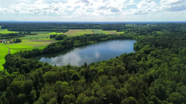 Steinsee bei Munchen Luftaufnahme. Steinsee, See in Bayern Luftbildansicht. Lake Stein aerial view near Munich, Bavaria, Germany. One of warmest lakes in Germany. Steinsee is located in forest area. 