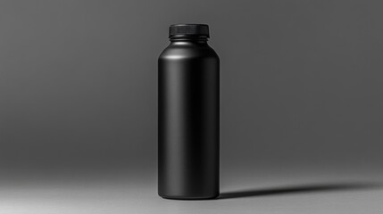 Black Metallic Water Bottle With Black Cap on Grey Table Under Studio Lighting