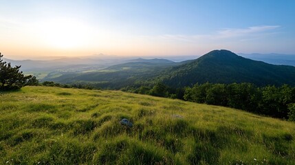 Obraz premium Scenic Panoramic View of Lush Green Hills and Majestic Mountains Under a Beautiful Sunset : Generative AI