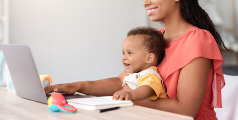 Kids And Technologies. African American Baby Boy Using Laptop With Mom At Home, Cropped