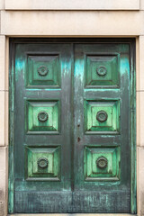 A Green Paneled Door on a Mausoleum in a Cemetery in Buenos Aires, Argentina with a Rich Patina of Age