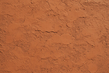 Smooth plaster wall texture in warm orange tones, ideal for backgrounds or design projects. matte finish adds subtle elegance to any space
