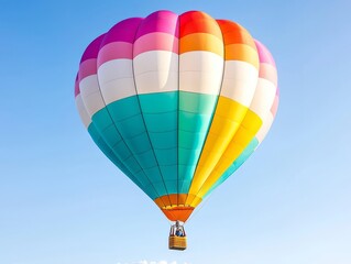 Naklejka premium Colorful hot air balloon soaring in clear blue sky over scenic landscape