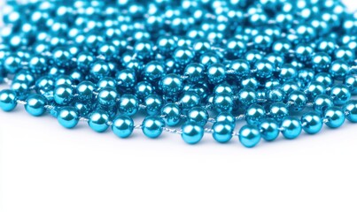 A vibrant close-up of shiny blue beads scattered on a white surface, creating a festive atmosphere