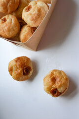 Close up view of Sourdough Focaccia Bread Muffins with pepperoni on white background in selective focus.