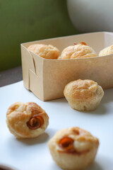Close up view of Sourdough Focaccia Bread Muffins with pepperoni on white background in selective focus.