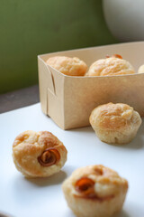 Close up view of Sourdough Focaccia Bread Muffins with pepperoni on white background in selective focus.