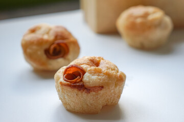 Close up view of Sourdough Focaccia Bread Muffins with pepperoni on white background in selective focus.