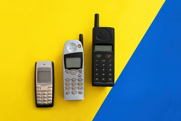 Retro cellphone on a blue yellow background