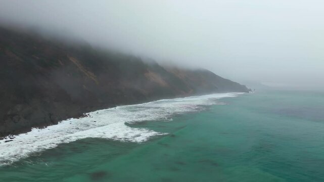 Waves black sand rugged coastline USAL Beach Campground Lost Coast Trail California aerial drone fog mist rain cloudy morning Pacific Ocean PNW Nor Cali mountainside circle left motion
