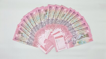 Indonesian banknotes are arranged like folding hand fan. Collection of 100,000 rupiah banknotes