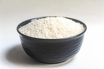 a bowl of raw rice on a white background