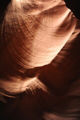 Silhouetted Figures Exploring the Narrow Pathways of Antelope Canyon in Arizona