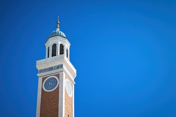 Mosque minaret against vibrant blue sky