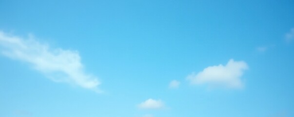 Fototapeta premium Soft focus blue sky with thin wispy white clouds against a bright blue background, blue sky, cloudy sky, atmospheric effects