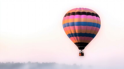 Fototapeta premium Colorful Hot Air Balloon Soaring Over Misty Landscape