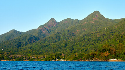 Kayaking to a Tropical Island with Majestic Mountain Peaks
