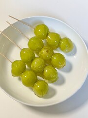 Tanghulu, a traditional Chinese snack made of skewered fruits, usually covered in a shiny sugar coating. Sweet and crunchy, this street food treat is a delightful combination of flavors and textures.
