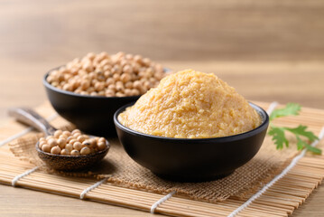 Miso paste in black bowl, Japanese seasoning made from fermenting soybeans with salt, Traditional...