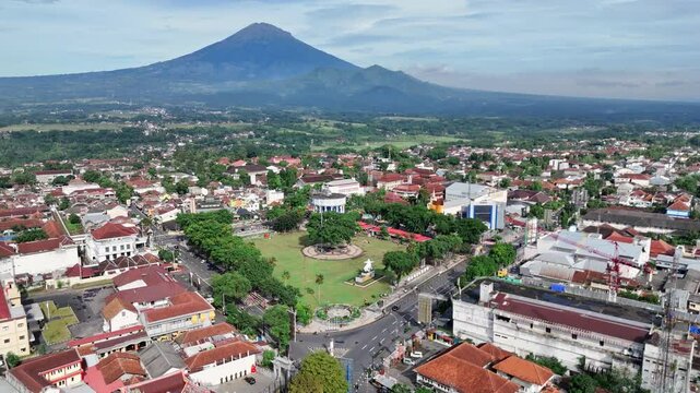 Aerial view urban landscape of Magelang City square with Mount Sumbing in the background, Central Java, Indonesia.
