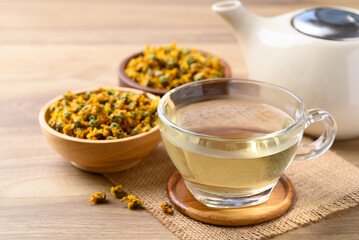 Chrysanthemum tea in cup glass with dried Chrysanthemum flowers, Healthy herbal drink
