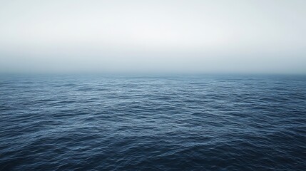 Obraz premium Calm Blue Ocean with Gentle Waves and Foggy Horizon View