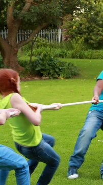 Cute pupils having a tug of war