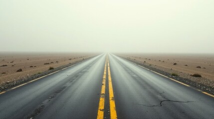 Fototapeta premium A misty, desolate highway stretches endlessly into the fog, a lonely road vanishing into the gray horizon, conveying a sense of mystery and solitude.