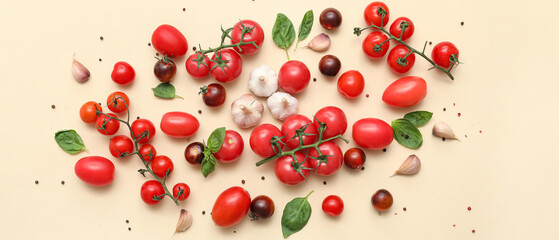 Fresh ripe tomatoes with garlic, basil and peppercorn on beige background