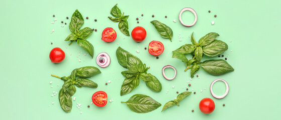 Fresh basil, cherry tomatoes and peppercorn on green background