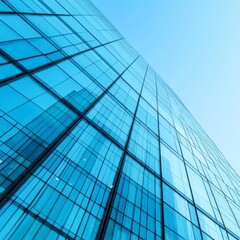 Modern skyscraper with reflective glass facade under a clear blue sky