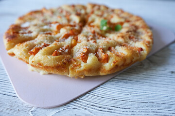 Apricot pie on a white wooden background.
